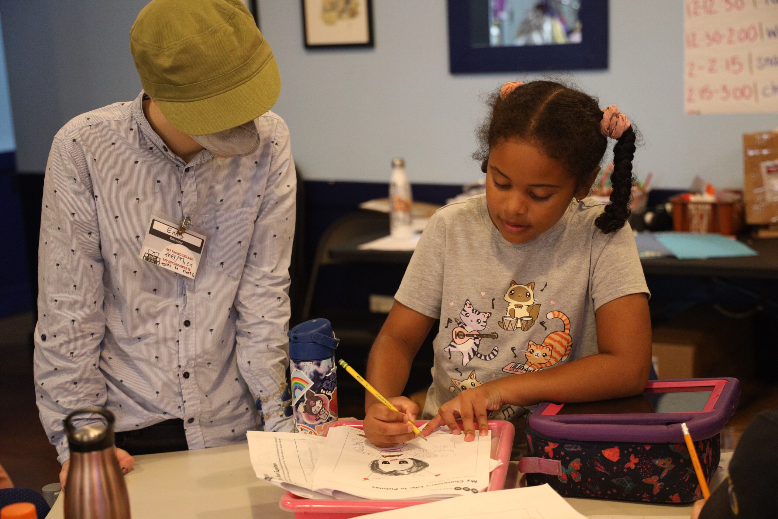 A student in the comics and heroes summer camp works on their comic illustrations.