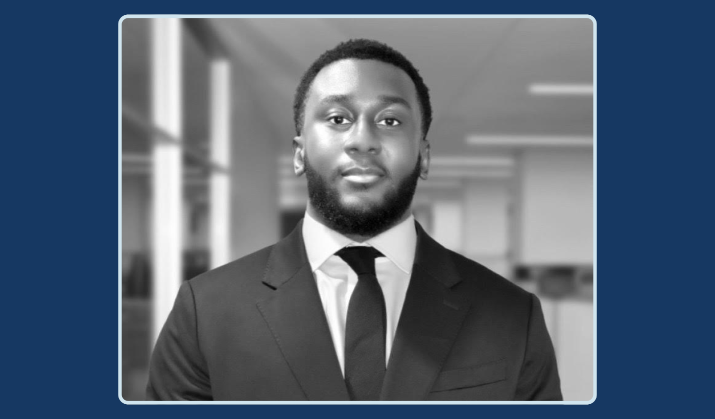 Black and white image of Kwaku Owusu in a suit.